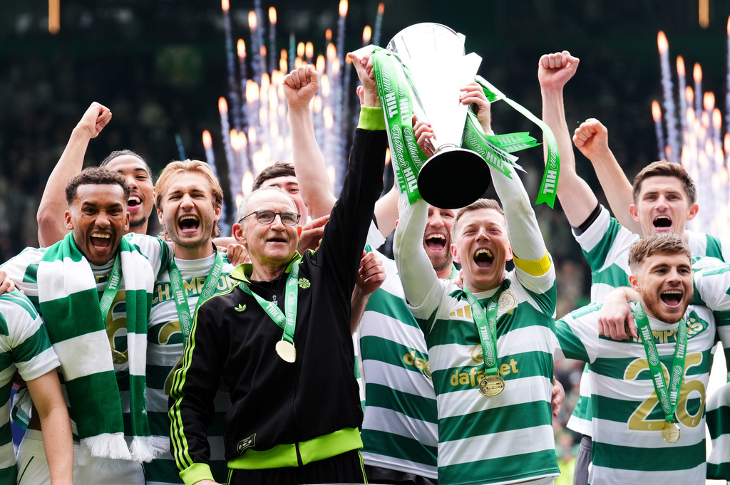 Celtic manager Martin O'Neill and Callum McGregor hold the Scottish Premier League Trophy following his side's title deciding match against Heart of Midlothian at Celtic Park, in Glasgow, Scotland, Saturday May 16, 2026. (Andrew Milligan/PA via AP)