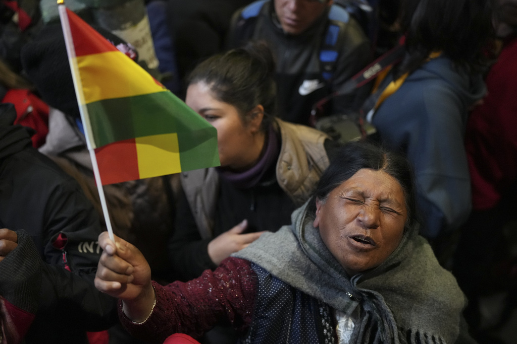 A supporter of presidential candidate Rodrigo Paz celebrates early results showing a lead in the presidential election in La Paz, Bolivia, Sunday, Aug. 17, 2025. (AP Photo/Natacha Pisarenko)
