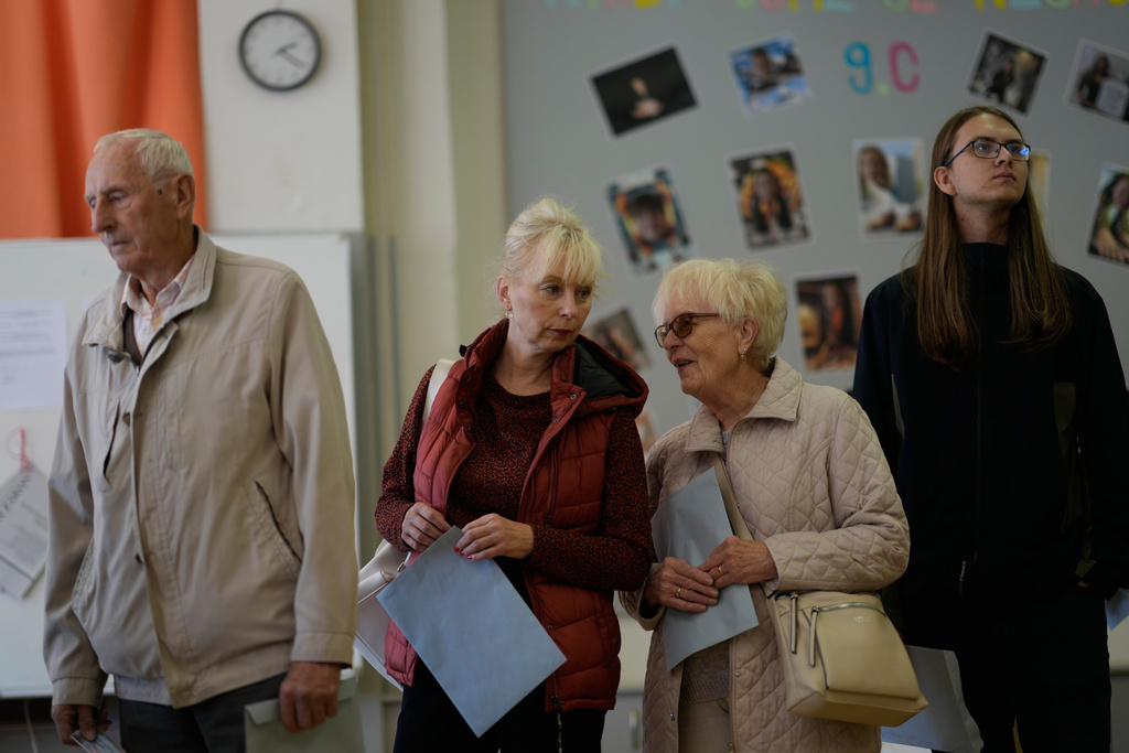 CAPTION CORRECTS LOCATION - People wait in line at a polling station for a general election at a poling station in Brno, Czech Republic, Friday, Oct. 3, 2025. (AP Photo/Darko Bandic)