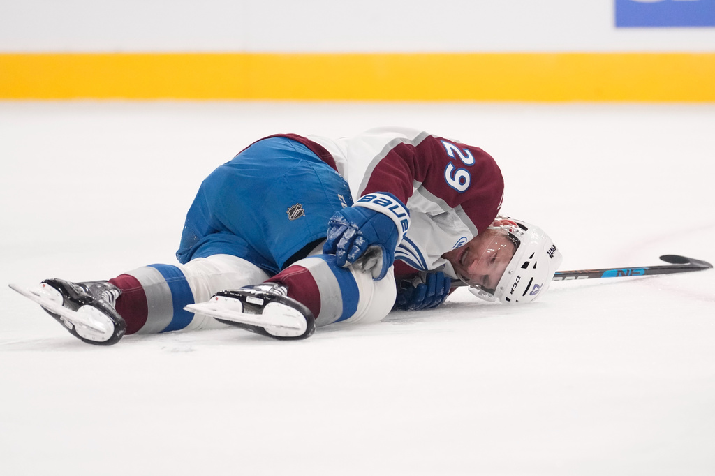 Colorado Avalanche center Nathan MacKinnon lays on the ice after being injured during the second period in Game 3 of the Western Conference finals NHL hockey Stanley Cup playoff series against the Vegas Golden Knights, Sunday, May 24, 2026, in Las Vegas. (AP Photo/Mark J. Terrill)