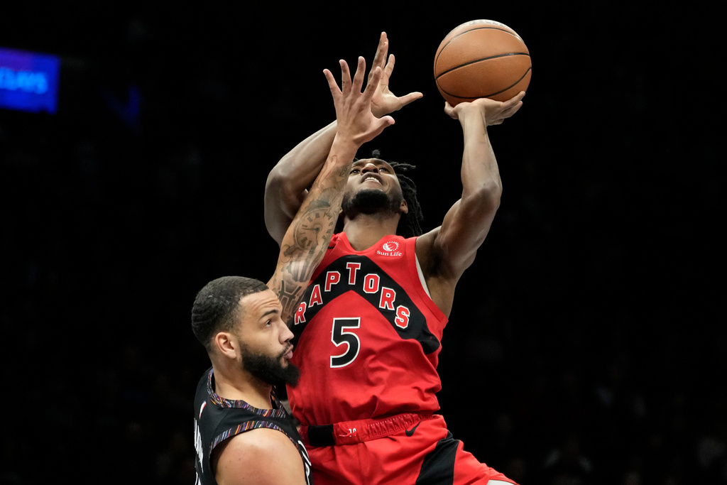 Toronto Raptors guard Immanuel Quickley (5) looks to shoot over Brooklyn Nets guard Tyrese Martin during the first half of an NBA basketball game, Sunday, Dec. 21, 2025, in New York. (AP Photo/Yuki Iwamura)