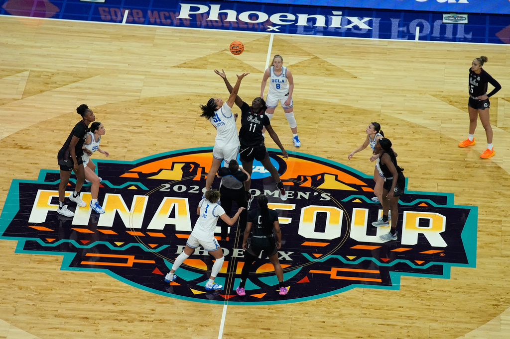 UCLA center Lauren Betts (51) and South Carolina center Madina Okot (11) battle for a tip-off during the first half of the women's National Championship Final Four NCAA college basketball tournament game between UCLA and South Carolina, Sunday, April 5, 2026, in Phoenix. (AP Photo/John Locher)