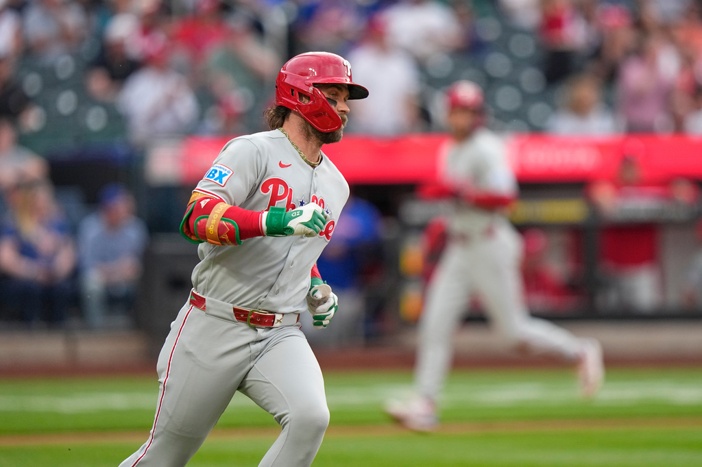 Philadelphia Phillies' Bryce Harper runs to first base for an RBI single during the first inning of a baseball game against the New York Mets Friday, June 26, 2026, in New York. (AP Photo/Frank Franklin II)