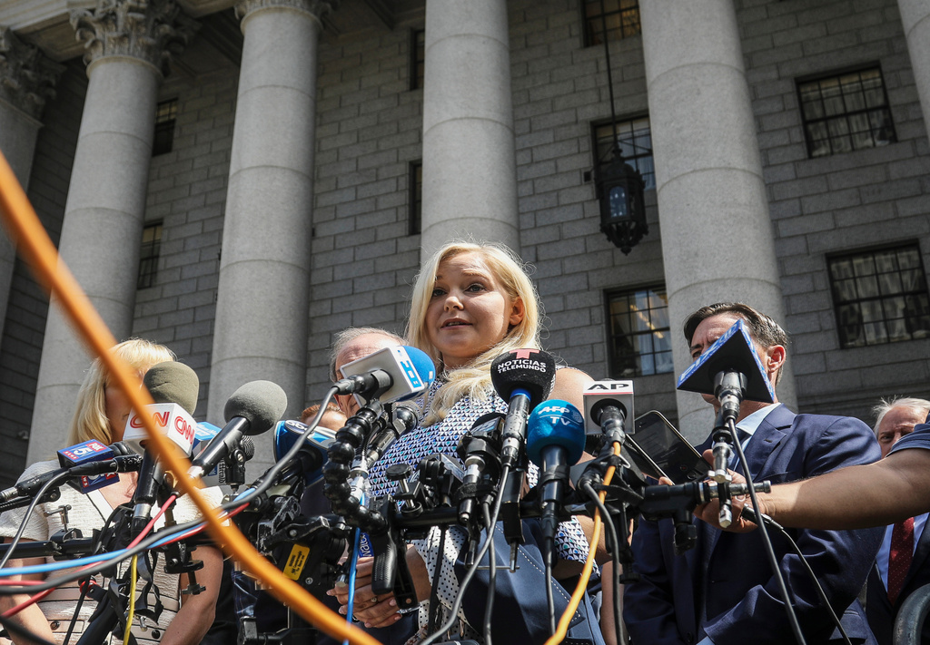 FILE - Virginia Roberts Giuffre, center, who says she was trafficked by sex offender Jeffrey Epstein, holds a news conference outside a Manhattan court where sexual assault claimants invited by a judge addressed a hearing following Epstein's jailhouse death in New York, Aug. 27, 2019. (AP Photo/Bebeto Matthews, File)