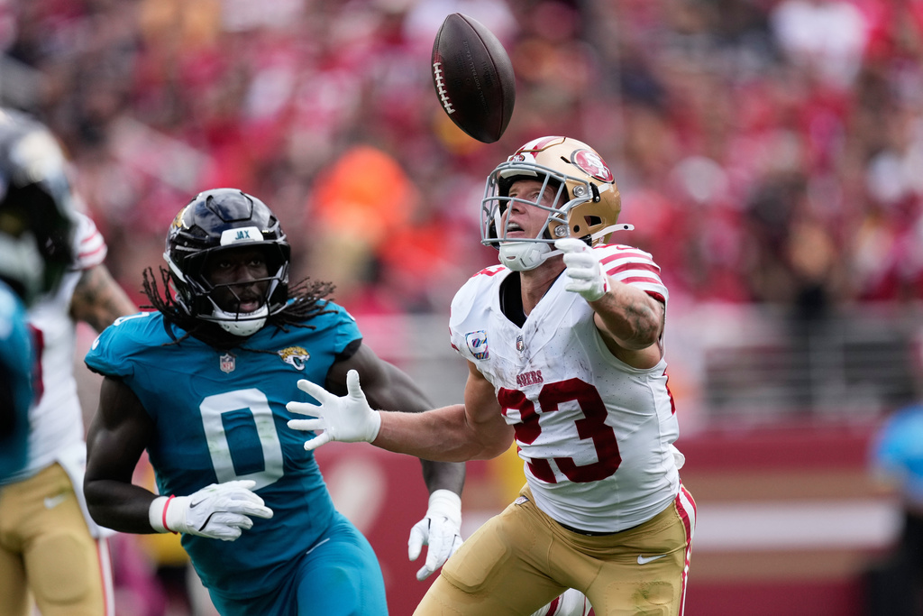 San Francisco 49ers running back Christian McCaffrey (23) cannot catch a pass, which was intercepted by Jacksonville Jaguars linebacker Devin Lloyd (0), during the first half of an NFL football game in Santa Clara, Calif., Sunday, Sept. 28, 2025. (AP Photo/Godofredo A. Vásquez)