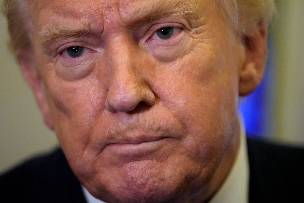 President Donald Trump listens to a reporter's question as he flies aboard Air Force One from Joint Base Andrews, Md., to West Palm Beach, Fla., Friday, Feb. 6, 2026 (AP Photo/Mark Schiefelbein)