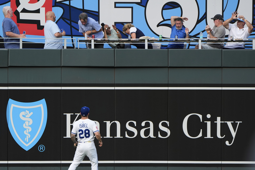 Kansas City Royals center fielder Kyle Isbel watches a solo home run hit by Texas Rangers' Corey Seager during the first inning of a baseball game against the Kansas City Royals, Tuesday, Aug. 19, 2025, in Kansas City, Mo. (AP Photo/Charlie Riedel)