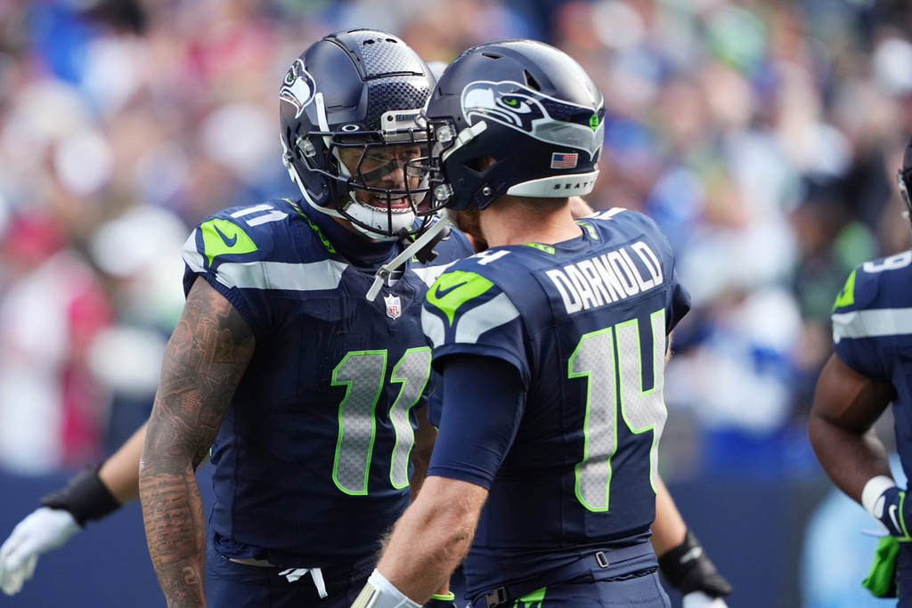 Seattle Seahawks wide receiver Jaxon Smith-Njigba (11) celebrates his touchdown catch against the Arizona Cardinals with Seahawks quarterback Sam Darnold (14) during the first half of an NFL football game Sunday, Nov. 9, 2025, in Seattle. (AP Photo/Lindsey Wasson)