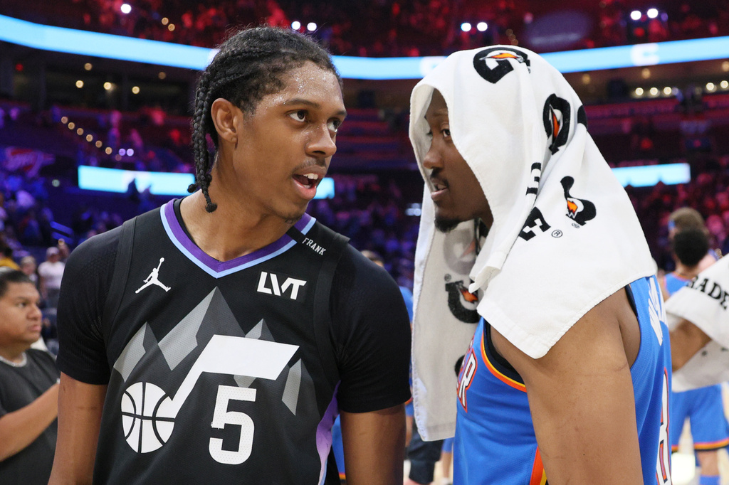 Brothers Utah Jazz forward Cody Williams (5) and Oklahoma City Thunder guard Jalen Williams talk after an NBA basketball game Sunday, April 5, 2026, in Oklahoma City. (AP Photo/Nate Billings)