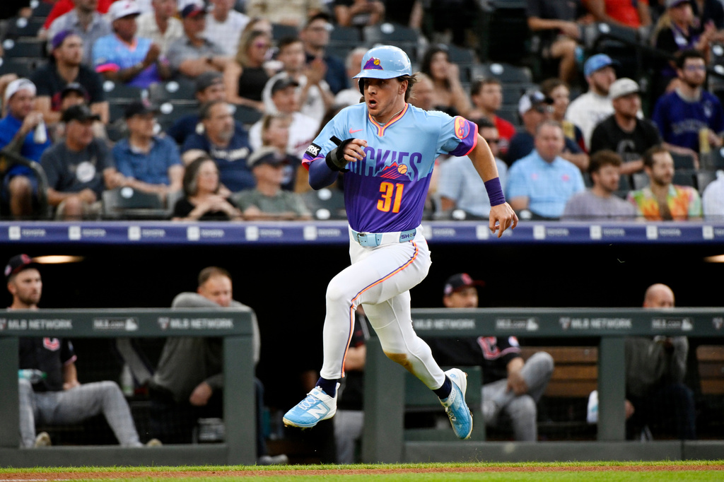 Colorado Rockies' Jake McCarthy runs to score on an RBI single hit by Willi Castro in the first inning of a baseball game against the Cleveland Guardians, Friday, Aug. 21, 2026, in Denver. (AP Photo/Geneva Heffernan)