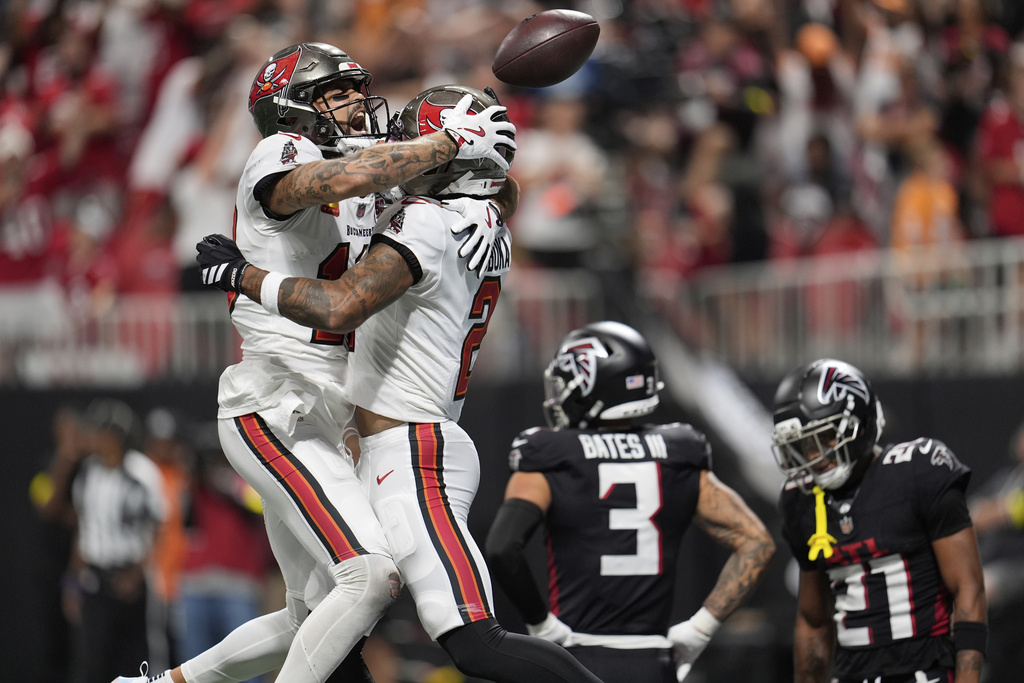 Tampa Bay Buccaneers wide receiver Mike Evans (13) celebrates with Tampa Bay Buccaneers wide receiver Emeka Egbuka (2) after Egbuka's touchdown during the second half of an NFL football game, Sunday, Sept. 7, 2025, in Atlanta. (AP Photo/Mike Stewart)