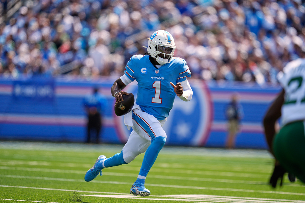 Tennessee Titans quarterback Cam Ward (1) runs for a first down during the first half of an NFL football game against the New York Jets, Sunday, Sept. 13, 2026, in Nashville, Tenn. (AP Photo/George Walker IV)