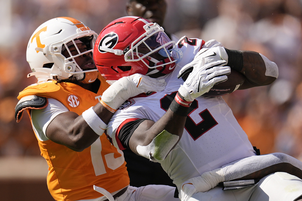 Tennessee linebacker Edwin Spillman (13) tackles Georgia running back Josh McCray (2) during the first half of an NCAA college football game Saturday, Sept. 13, 2025, in Knoxville, Tenn. (AP Photo/George Walker IV)
