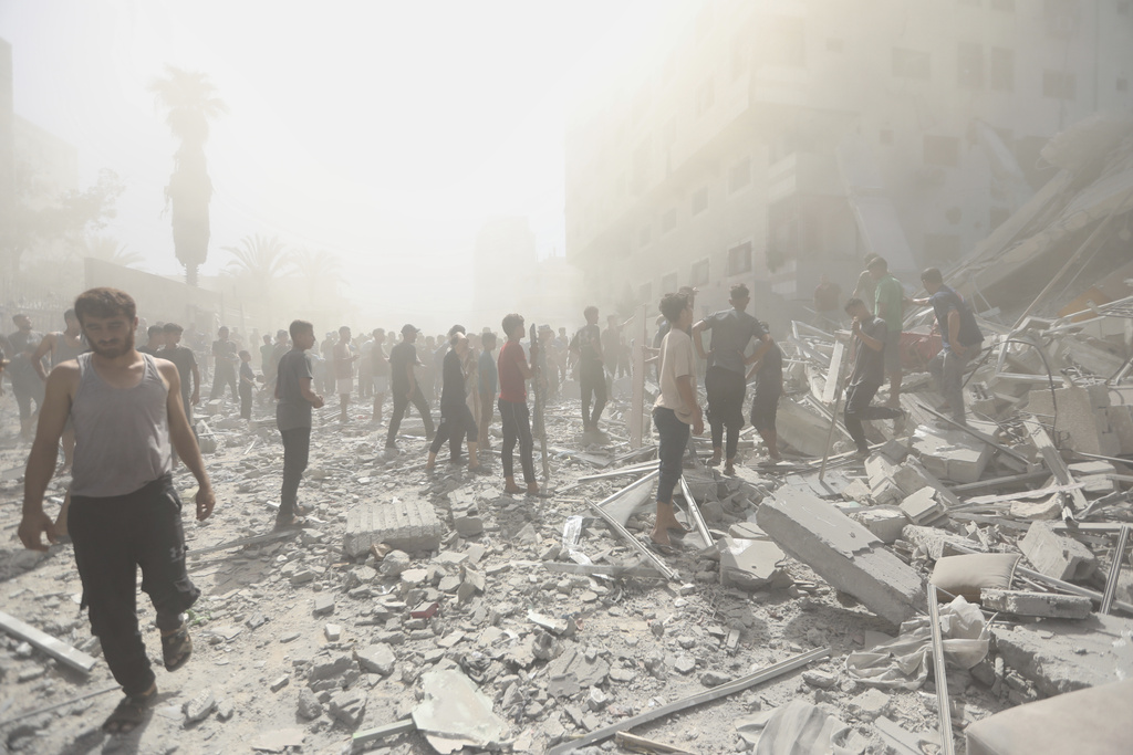 Palestinians inspect the rubble of a building after an Israeli military strike in Gaza City, Sunday, Sept. 14, 2025. (AP Photo/Yousef Al Zanoun)