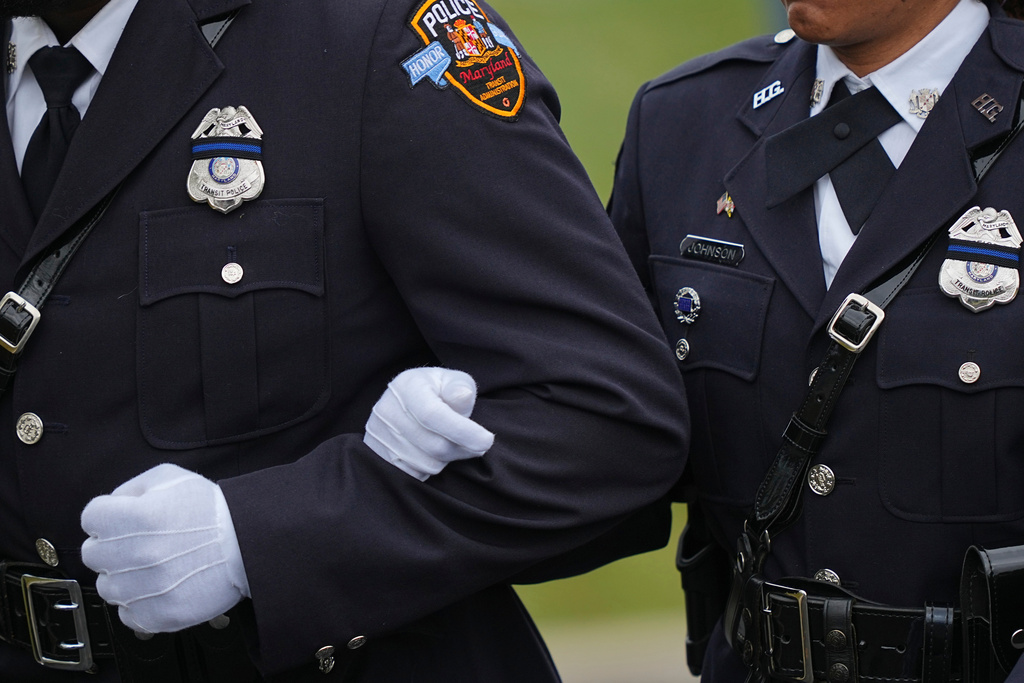 Officers stand arm and arm during funeral services for slain Northern York County Regional Police detectives Cody Michael Becker, Mark Edward Baker and Isaiah Emenheiser, Thursday, Sept. 25, 2025, in Red Lion, Pa. (AP Photo/Matt Rourke)