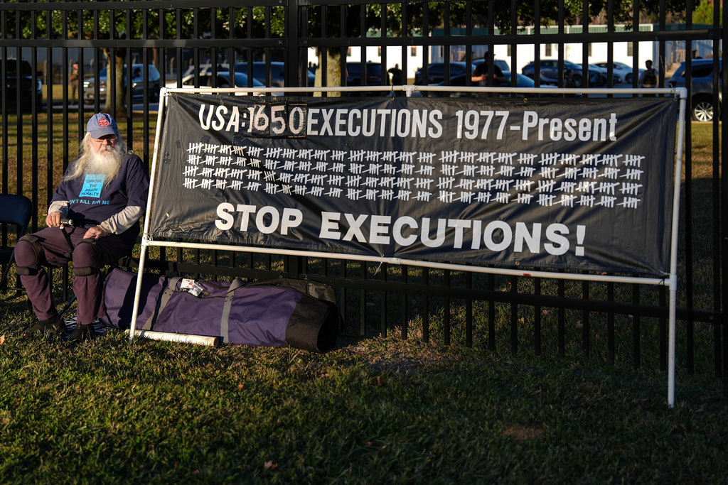 A protester looks on outside of Broad River Correctional Institute prior to the scheduled execution of Stephen Bryant in Columbia, S.C., Friday, Nov. 14, 2025. (AP Photo/Matt Kelley)