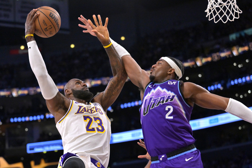 Los Angeles Lakers forward LeBron James (23) goes up to shoot over Utah Jazz forward Blake Hinson (2) for a basket during the first half of an NBA basketball game Sunday, April 12, 2026, in Los Angeles. (AP Photo/Jayne Kamin-Oncea)