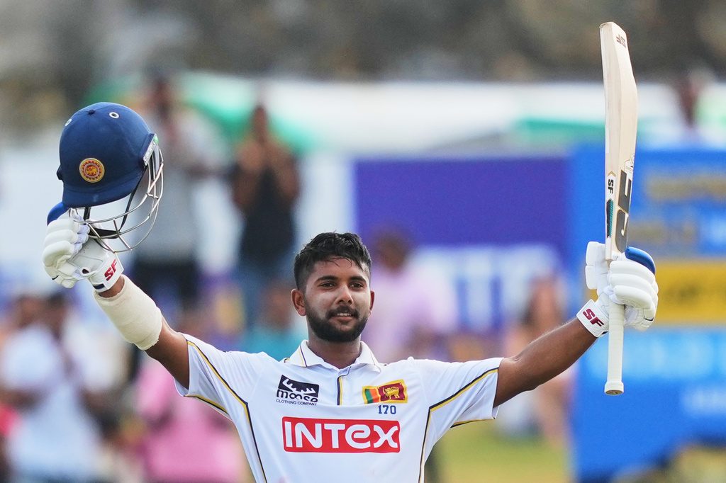 Sri Lanka's Sonal Dinusha celebrates his century during the day three of the first cricket test match between Sri Lanka and India In Galle, Sri Lanka, Monday, Aug. 17, 2026. (AP Photo/Eranga Jayawardena)