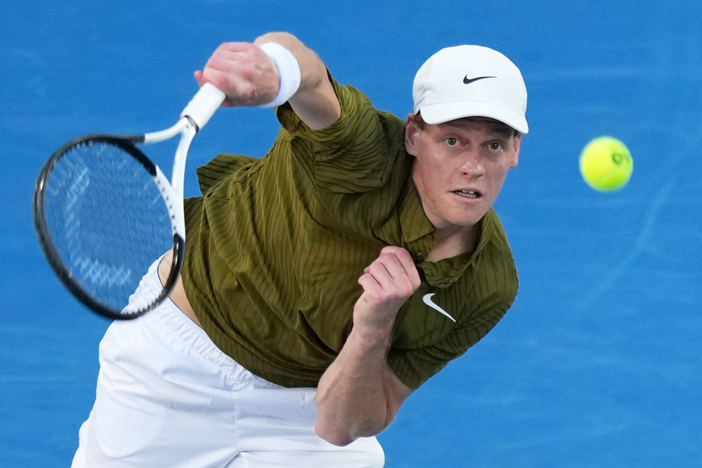 Jannik Sinner of Italy serves to his compatriot Luciano Darderi during their fourth round match at the Australian Open tennis championship in Melbourne, Australia, Monday, Jan. 26, 2026. (AP Photo/Aaron Favila)
