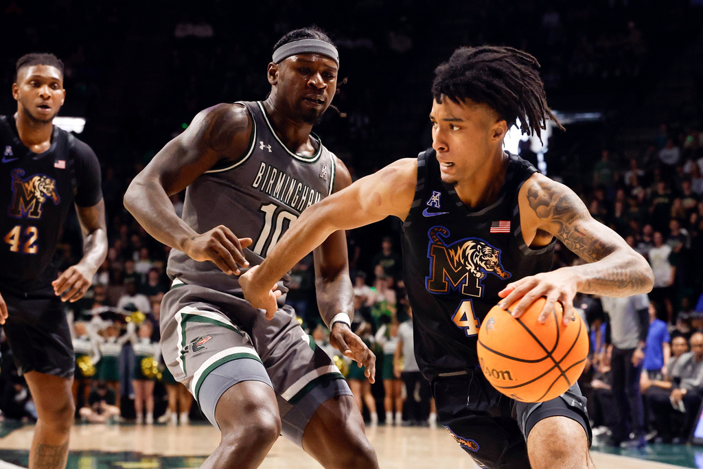 FILE - Memphis guard PJ Haggerty (4) , who has since transferred Kansas State, drives to the basket around UAB guard Alejandro Vasquez during the first half of an NCAA college basketball game, Sunday, March 2, 2025, in Birmingham, Ala. (AP Photo/Butch Dill, File)