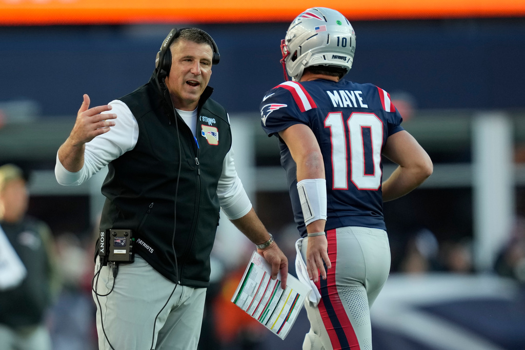 New England Patriots head coach Mike Vrabel speaks with quarterback Drake Maye (10) during the second half of an NFL football game against the Atlanta Falcons, Sunday, Nov. 2, 2025, in Foxborough, Mass. (AP Photo/Charles Krupa)