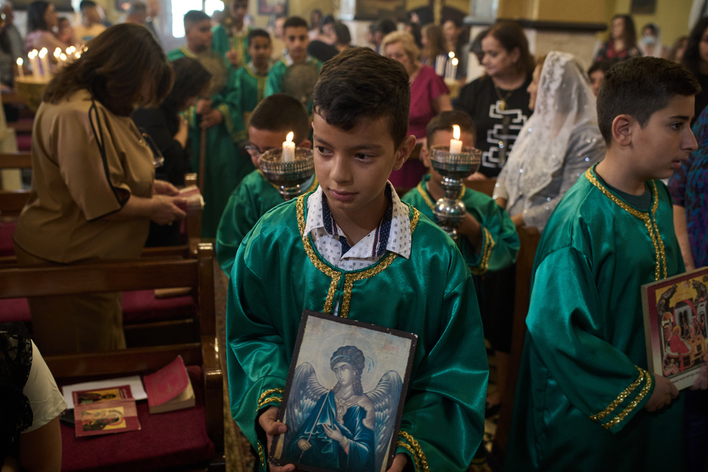 Palestinian children attend morning Mass at the Greek Orthodox Church of St. George in the West Bank village of Taybeh, Sept. 28, 2025. (AP Photo/Leo Correa)
