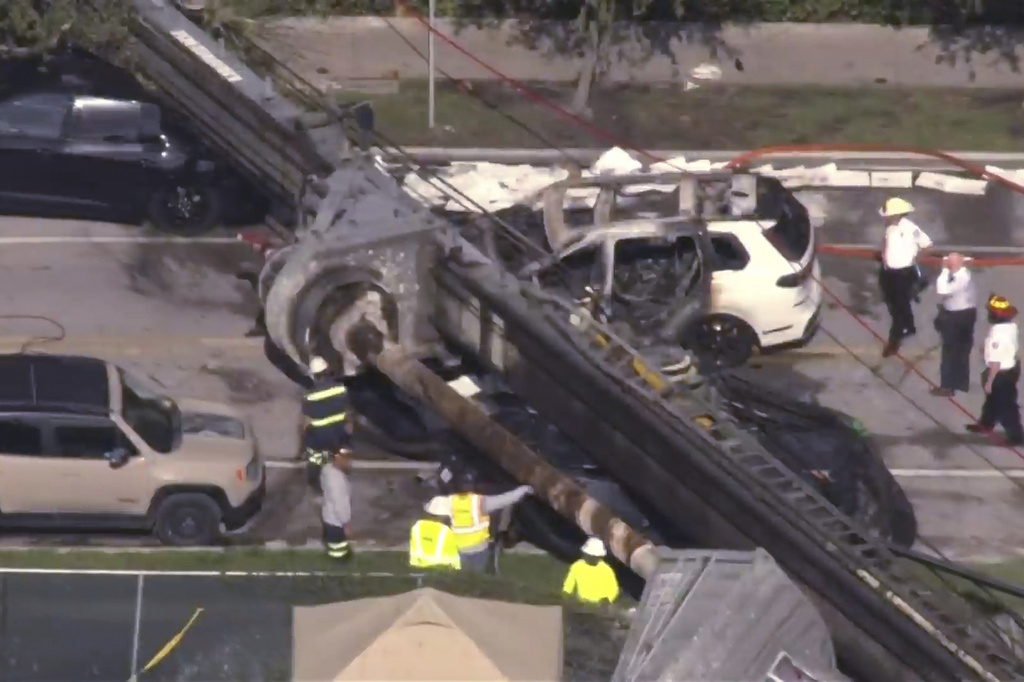 This image taken from a WSVN video shows Miami authorities responding to the scene of a crane that collapsed at a Miami construction site Monday, Sept. 14, 2026. (WSVN via AP)