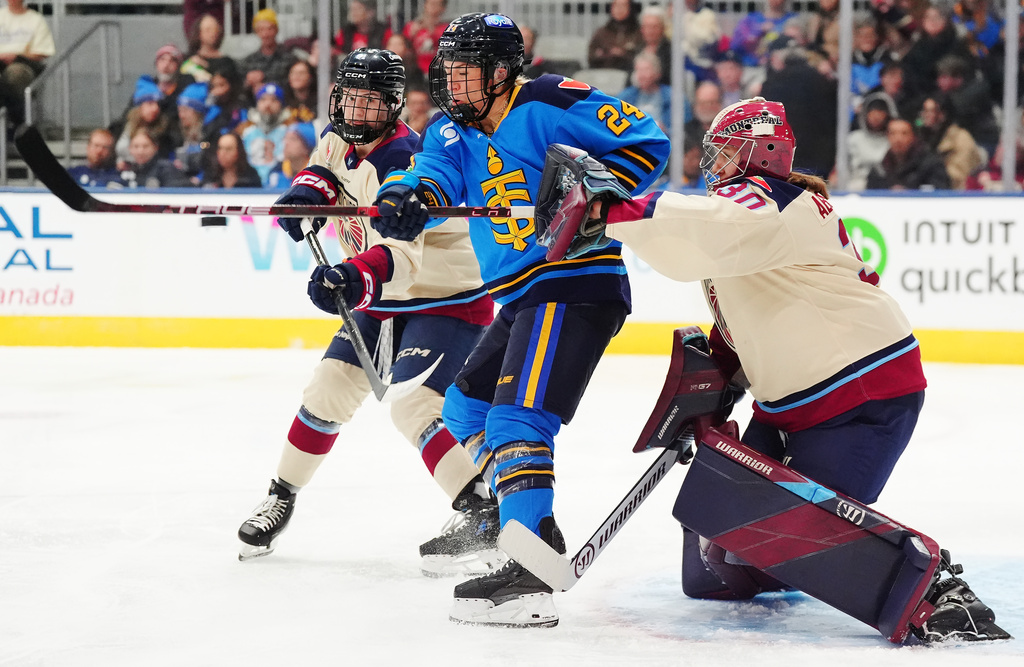 Toronto Sceptres' Natalie Spooner (24) tries to tip a shot in front of Montreal Victoire goaltender Sandra Abstreiter (30) as Nicole Gosling defends during the second period of an PWHL hockey game in Toronto, Tuesday, March 3, 2026. (Frank Gunn/The Canadian Press via AP)