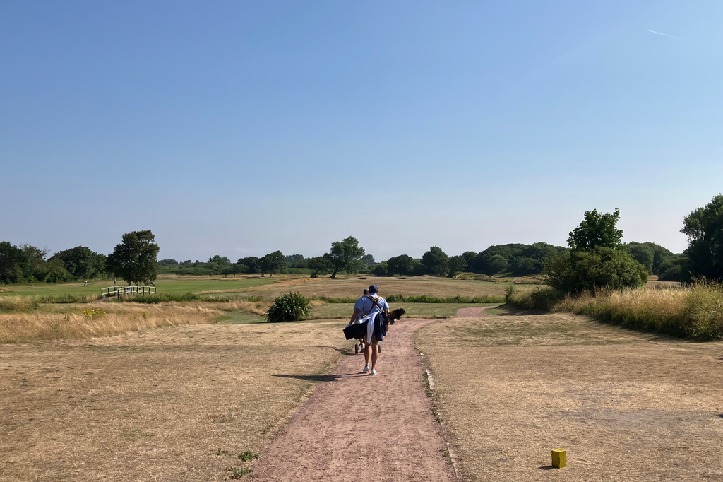 A person walks from the 1st tee on the Southport Golf Links in Southport, England, Wednesday July 15, 2026. (AP Photo Steve Douglas)