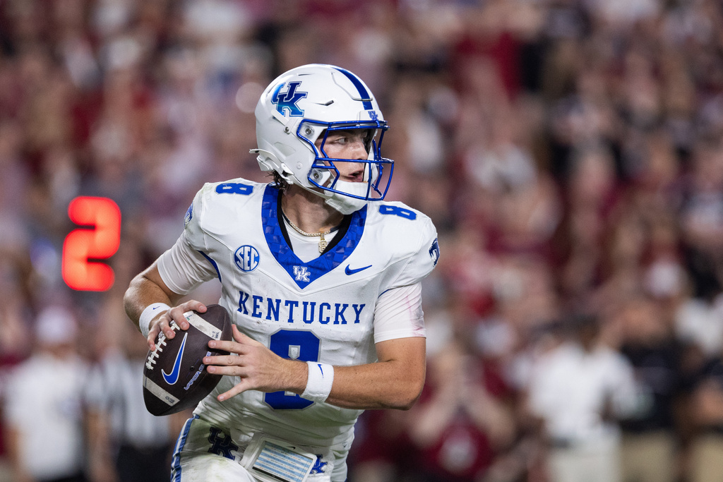 Kentucky quarterback Cutter Boley (8) rolls out against the South Carolina during the first half of an NCAA college football game, Saturday, Sept. 27, 2025, in Columbia, S.C. (AP Photo/Scott Kinser)