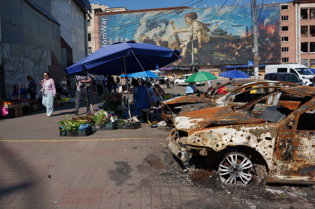 Destroyed cars sit after a Russian attack at the market in the Lukianivka neighbourhood of Kyiv, Ukraine, Thursday, June 11, 2026. (AP Photo/Evgeniy Maloletka)