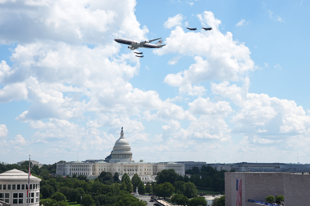 Air Force One flies near the U.S. Capitol before the IndyCar Freedom 250 Grand Prix auto race in Washington, Sunday, Aug. 23, 2026. (AP Photo/Jacquelyn Martin)