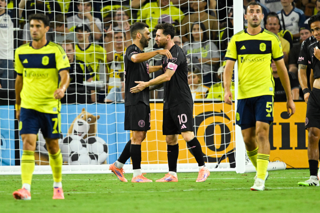Inter Miami forward Lionel Messi (10) celebrates his goal with defender Jordi Alba, second from left, as Nashville SC midfielder Gastón Brugman (7) and defender Jack Maher (5) walk away during the second half of a MLS soccer match Saturday, Oct. 28, 2025, in Nashville, Tenn. (AP Photo/John Amis)