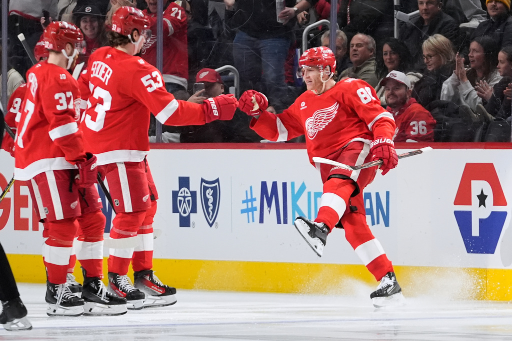Detroit Red Wings right wing Patrick Kane (88) celebrates his goal with Patrick Kane (88) against the Calgary Flames in the second period of an NHL hockey game Monday, March 16, 2026, in Detroit. (AP Photo/Paul Sancya)