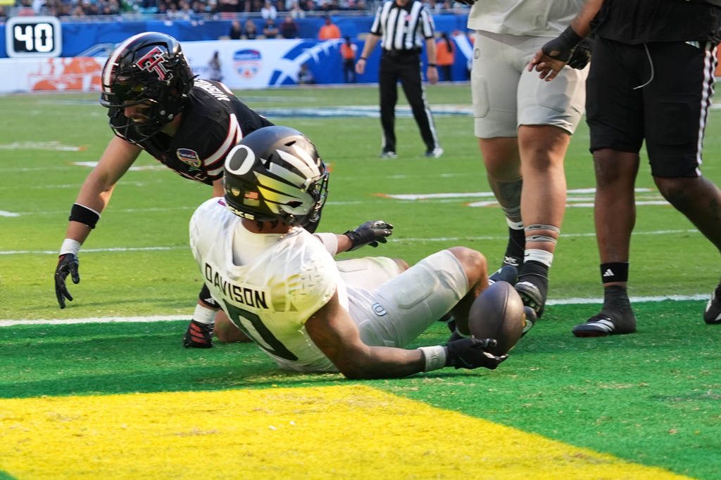 Oregon running back Jordon Davison (0) scores a touchdown during the second half of the Orange Bowl College Football Playoff quarterfinal game against Texas Tech, Thursday, Jan. 1, 2026, in Miami Gardens, Fla. (AP Photo/Lynne Sladky)