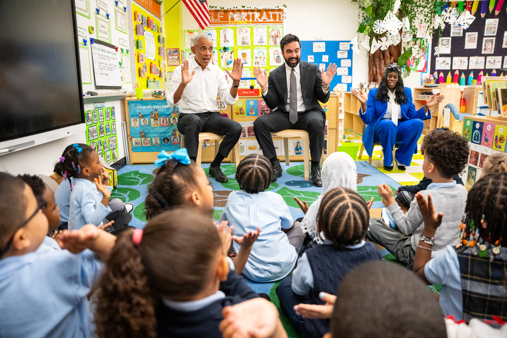 Former President Barack Obama and Mayor Zohran Mamdani sing "Wheels on the Bus" to children at Learning Through Play Pre-K in New York, Saturday, April 18, 2026. (AP Photo/Angelina Katsanis)