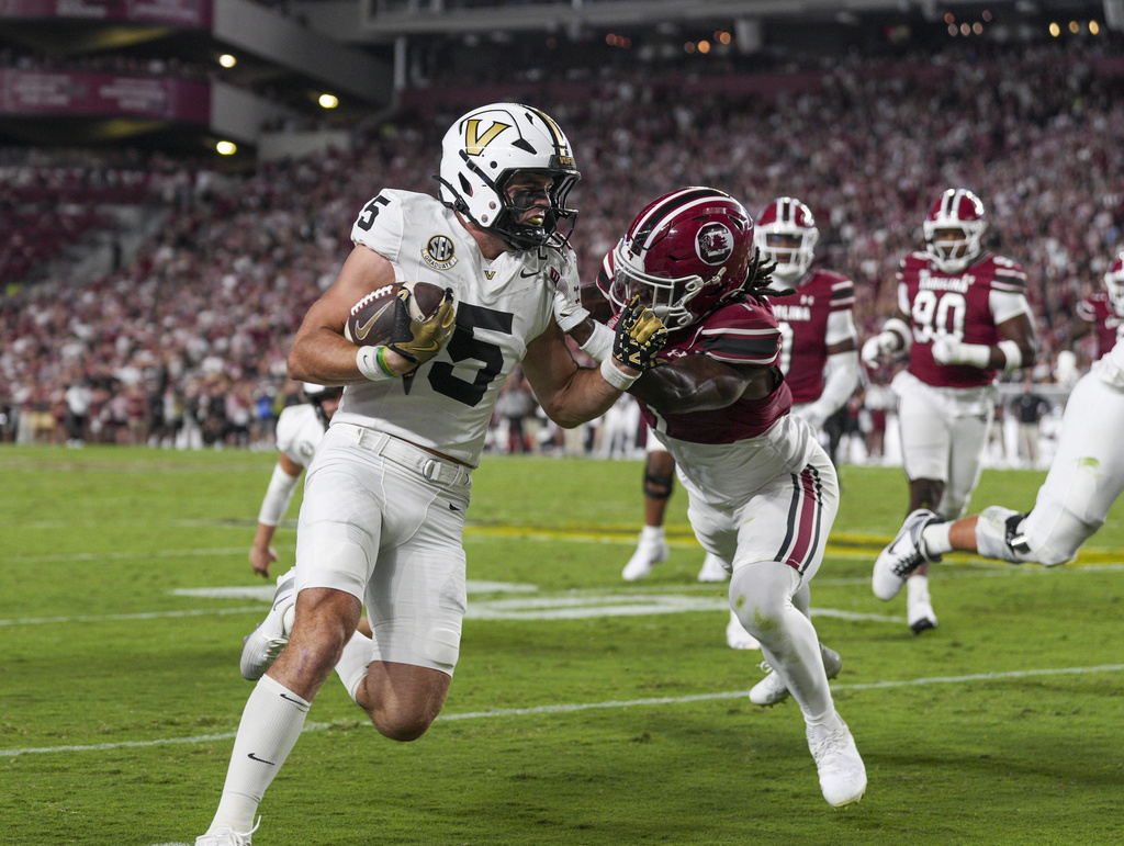 Vanderbilt wide receiver Richie Hoskins (5) is stopped by South Carolina defensive back DQ Smith, front right, in the first half of an NCAA college football game Saturday, Sept. 13, 2025, in Columbia, S.C. (AP Photo/David Yeazell)