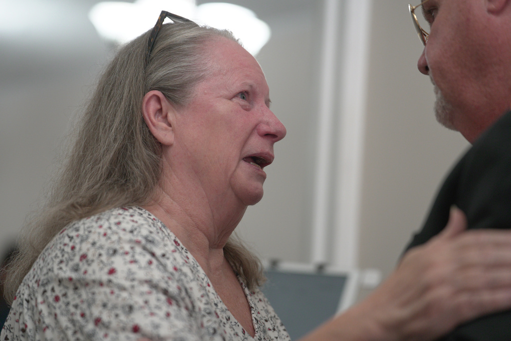 Pastor Jimmy Andrews of Maple Valley Baptist Church comforts a congregant whose grandson works at Accurate Energetic Systems following Sunday service on Oct. 12, 2025, in McEwen, Tenn. (AP Photo/Obed Lamy)