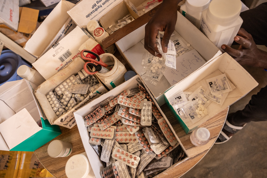 A pharmacist hands pregnant women painkillers from boxes at the pharmacy of the Birao District Hospital in the Central African Republic, Thursday, March 26, 2026. (AP Photo/Caitlin Kelly)