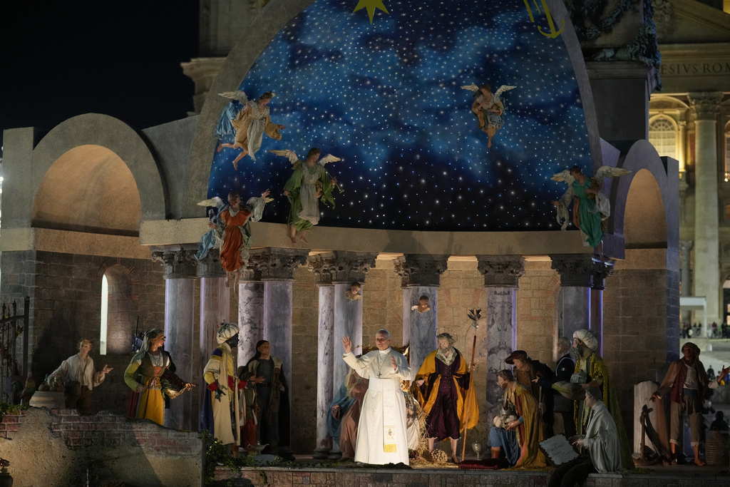 Pope Leo XIV waves after a moment of prayer in front of the nativity scene that adorns St.Peter's Square at the Vatican, Wednesday, Dec. 31, 2025. (AP Photo/Andrew Medichini)