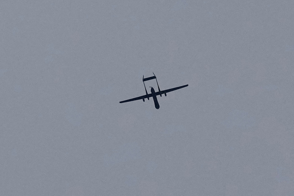 An Israeli drone flies over the southern port city of Tyre, Lebanon, Saturday, March 28, 2026. (AP Photo/Hussein Malla)