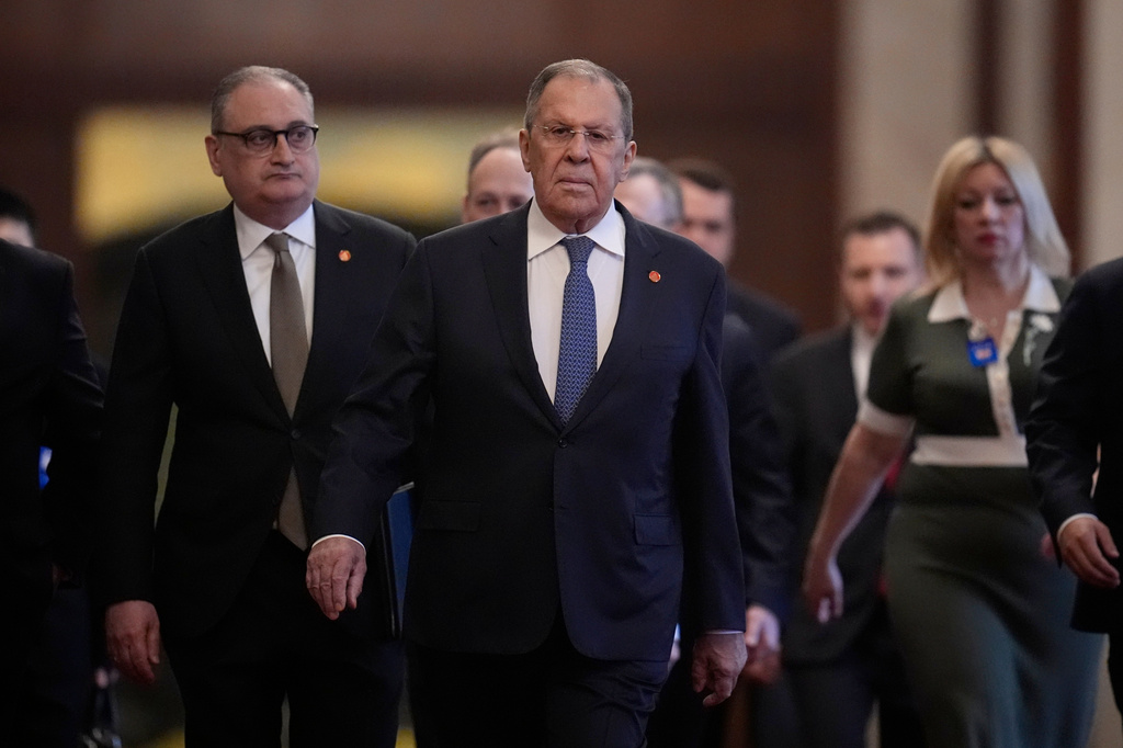 Russia's Foreign Minister Sergey Lavrov, center, walks for a meeting with China's President Xi Jinping, at the Great Hall of the People in Beijing, China Wednesday, April 15, 2026. (Iori Sagisawa/Pool Photo via AP)