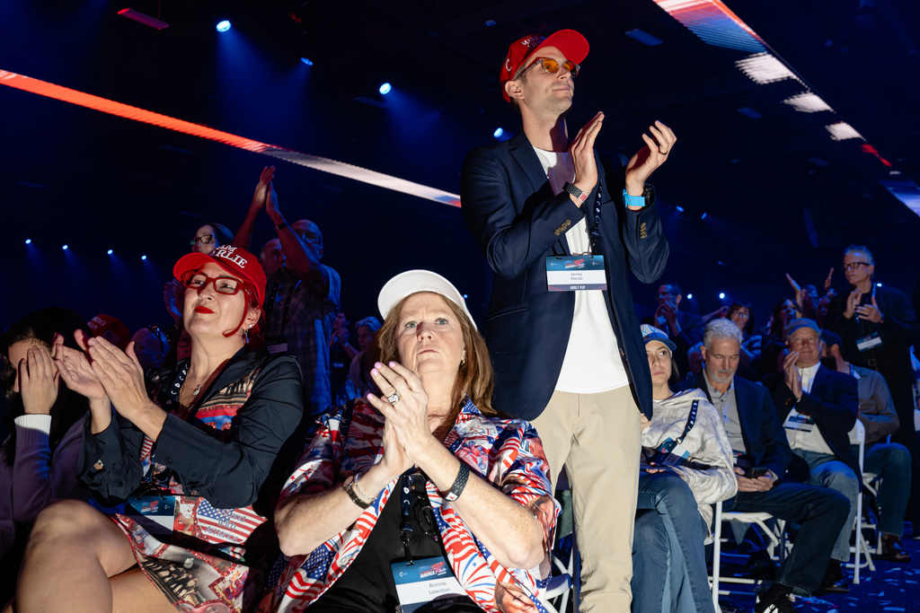 Attendees applaud during Turning Point USA's AmericaFest 2025, Saturday, Dec. 20, 2025, in Phoenix. (AP Photo/Jon Cherry)