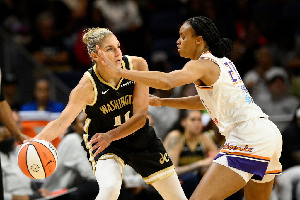 FILE - Washington Mystics forward Elena Delle Donne (11) looks to pass the ball as Phoenix Mercury forward Brianna Turner (21) defends during the first half of a WNBA basketball game, June 16, 2023, in Washington. (AP Photo/Nick Wass, File)