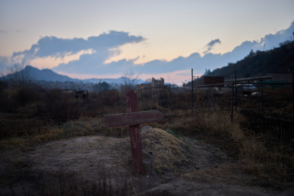 FILE - A cross is seen at a cemetery where hundreds of people who died of AIDS are buried in Maseru, Lesotho, July 20, 2025. (AP Photo/Bram Janssen, File)