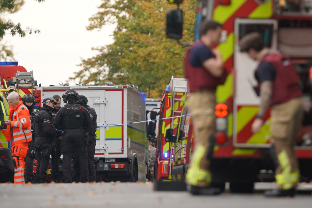 Emergency service workers at the scene of a stabbing incident at Heaton Park Hebrew Congregation synagogue, in Crumpsall, Manchester, England, Thursday, Oct. 2, 2025. (AP Photo/Ian Hodgson)