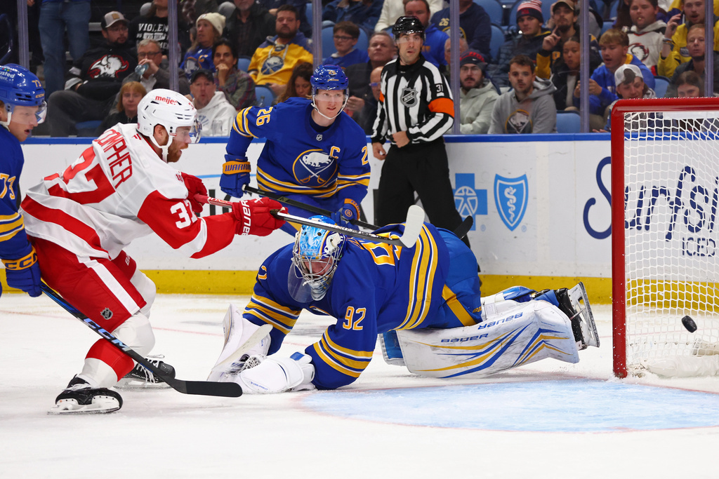 Detroit Red Wings left wing J.T. Compher (37) puts the puck past Buffalo Sabres goaltender Colten Ellis (92) during the second period of an NHL hockey game Wednesday, Oct. 22, 2025, in Buffalo, N.Y. (AP Photo/Jeffrey T. Barnes)