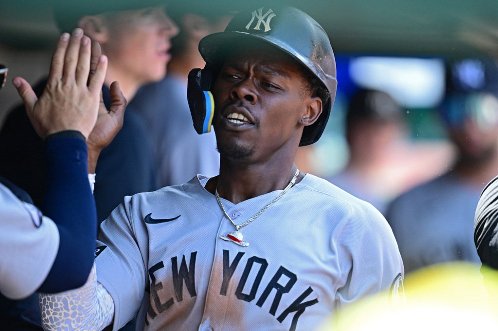 New York Yankees' Jazz Chisholm Jr. is congratulated in the dugout after scoring a run on an error by Cleveland Guardians second basemen Travis Bazzana during the second inning of a baseball game, Wednesday June 10, 2026, in Cleveland. (AP Photo/David Dermer)