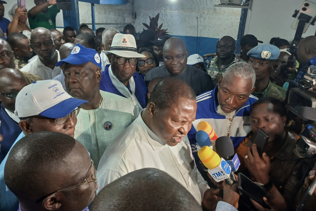 Central African Republic President Faustin Archange Touadéra, bottom center, speaks to the media after being declared the winner of the presidential election in Bangui, Central African Republic, Monday, Jan. 5, 2026. (AP Photo/Jean-Fernand Koena)