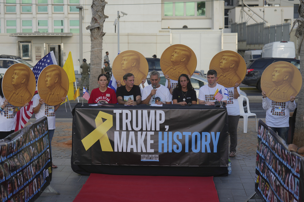 Demonstrators wear shits with photos depicting the faces of Israeli hostages who are being held in the Gaza Strip, during a protest demanding their release, outside the U.S. Embassy Branch Office in Tel Aviv on Tuesday, Sept. 2, 2025. (AP Photo/Ariel Schalit)